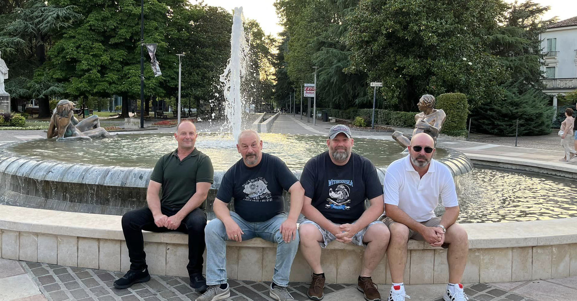 Group of motorcyclists sitting by a fountain in a charming town during a rest day in Germany’s Black Forest